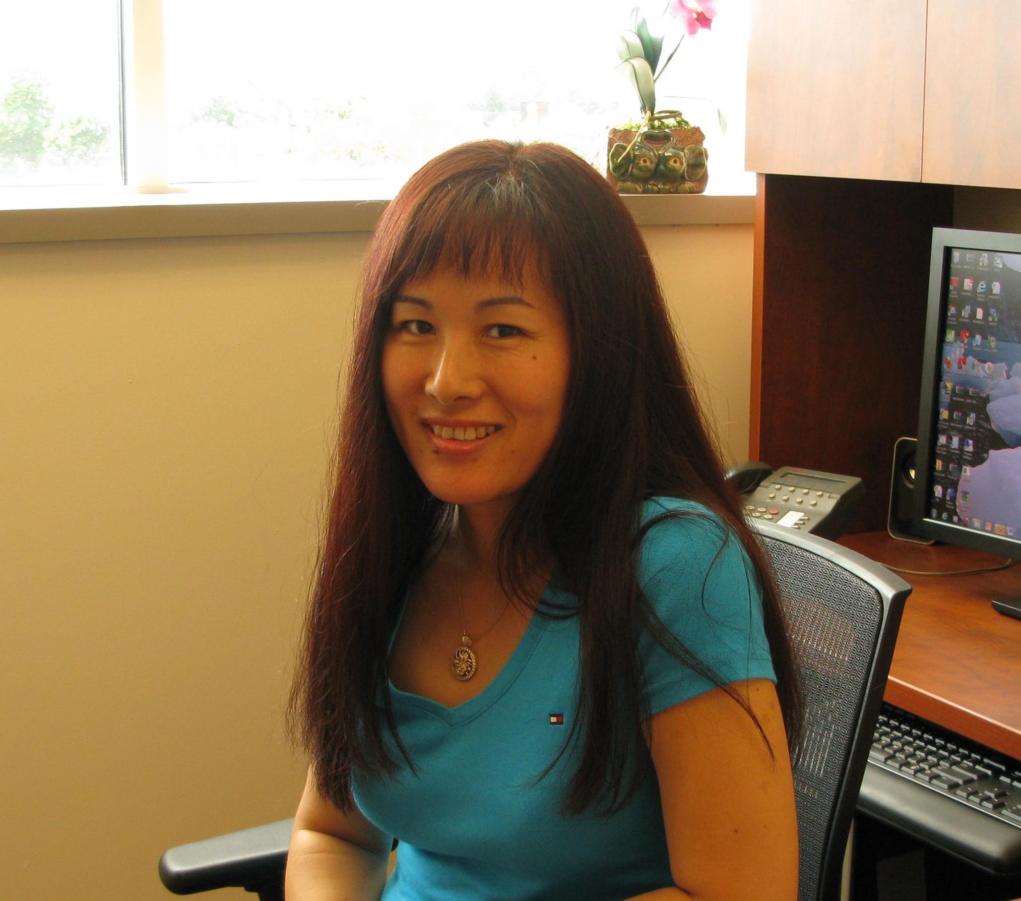 Xia Jiang sitting at her desk